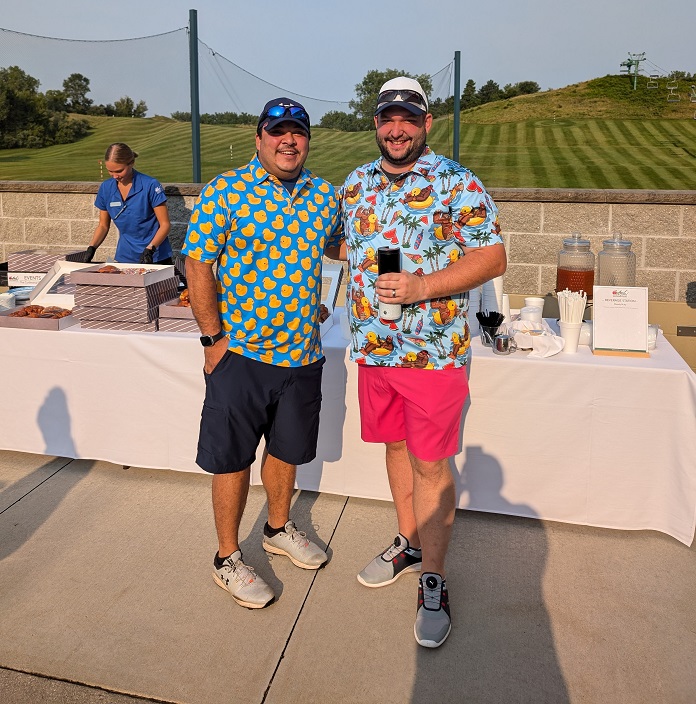 two golfers in duck shirts enjoying breakfast before golfing